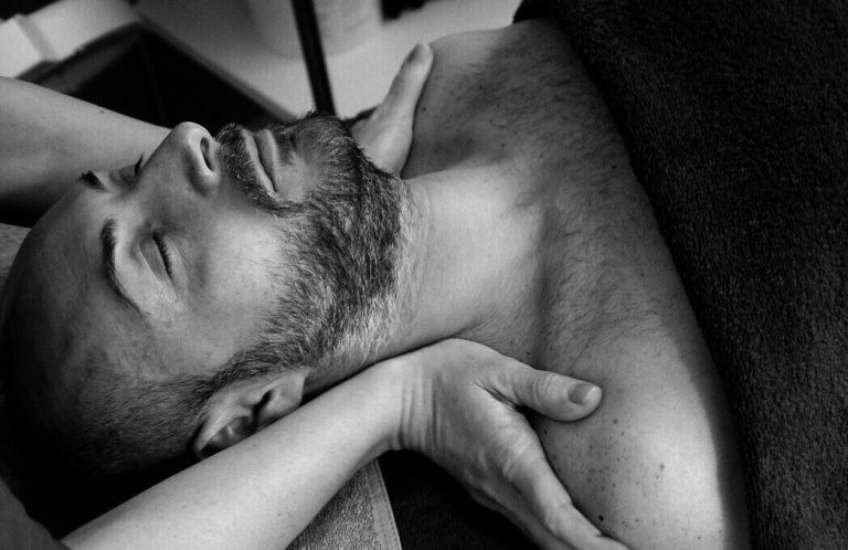 A man receiving a shoulder massage